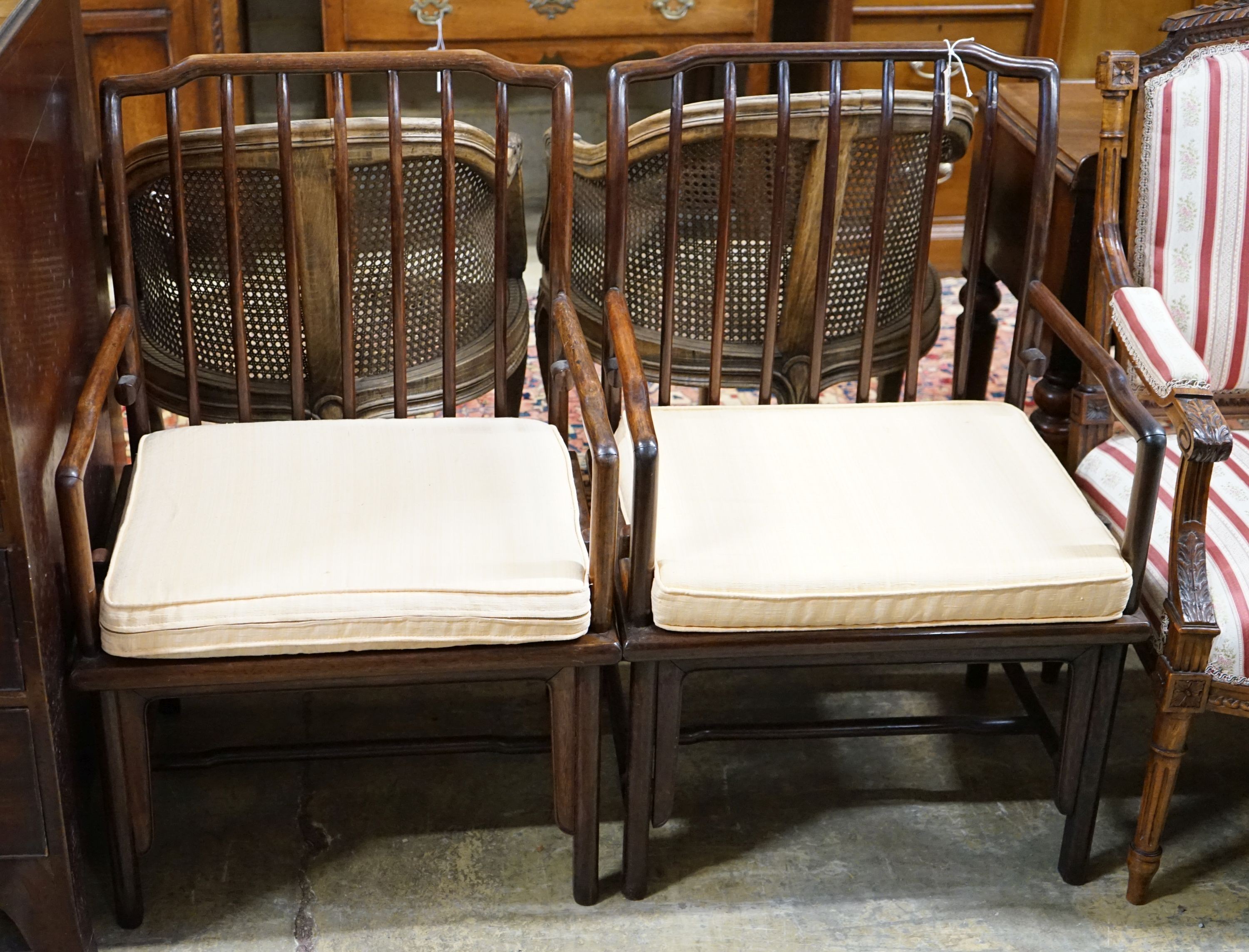 A pair of mid 20th century Chinese Hongmu elbow chairs with cushion seats, width 58cm, depth 49cm, height 92cm